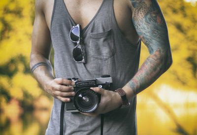 Close-up of photographer holding camera