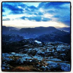 Scenic view of mountains against cloudy sky