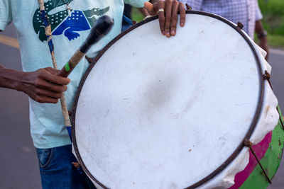 Musicians play percussion instruments during the levada do mastro procession to honor saint peter 