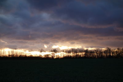 Silhouette of landscape against cloudy sky