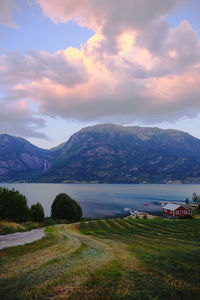 Scenic view of lake and mountains against sky