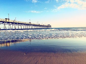 Pier on sea at sunset