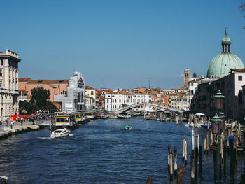 Bridge over canal against buildings in city