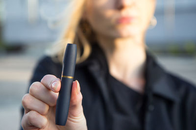 Close-up of woman hand holding camera