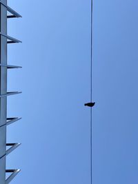 Low angle view of street light against clear blue sky