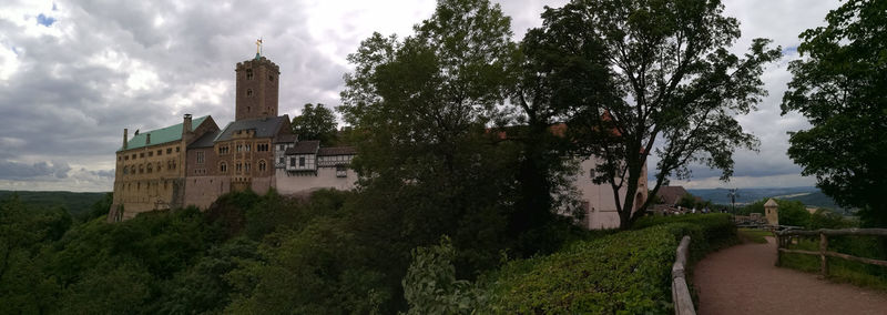 Trees and castle against sky