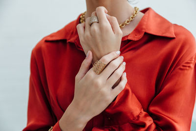 Midsection of woman holding red hat