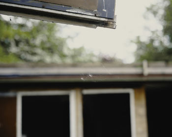 Low angle view of building seen through window