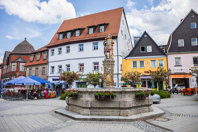 Buildings in town against sky