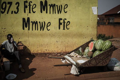 Men in front of text on wall