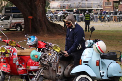 Rear view of people riding motor scooter on street