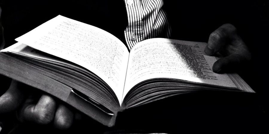 indoors, book, still life, paper, close-up, black background, no people, high angle view, table, education, studio shot, home interior, bed, sofa, white color, bedroom, selective focus, part of, pillow, open