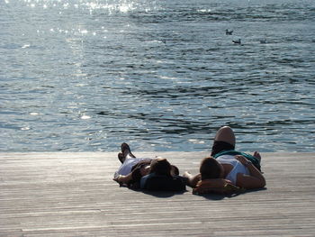 Rear view of couple relaxing at beach