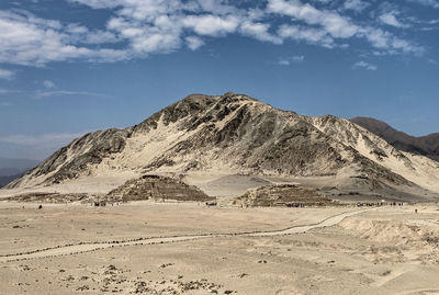 Scenic view of arid landscape against sky in caral