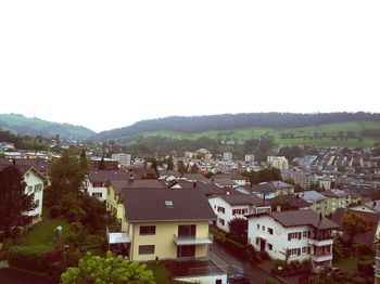 Houses in town against clear sky