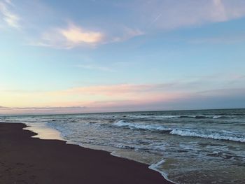 Scenic view of beach against sky during sunset