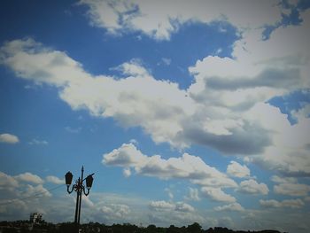 Low angle view of telephone pole against sky