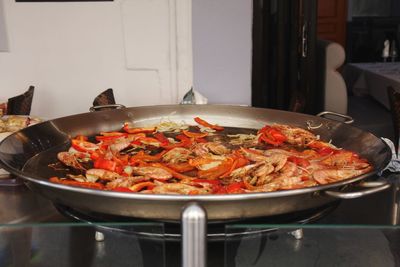 Close-up of meat in cooking pan on table