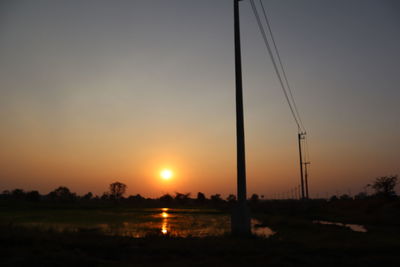 Scenic view of silhouette field against sky during sunset