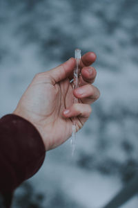 Close-up of hand holding ice