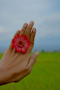 Flower between finger