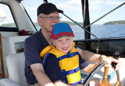 Full length of father with son in water