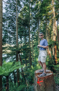 Portrait of man standing in forest