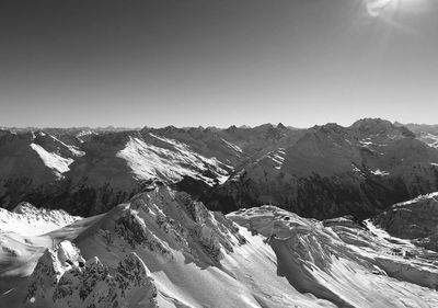 Scenic view of snowcapped mountains against clear sky