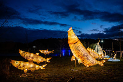 Panoramic view of illuminated traditional windmill against sky at night