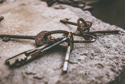 Close-up of rusty keys on rock