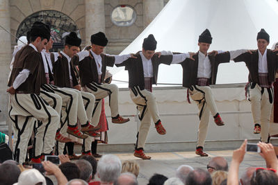 Spectators looking at traditional dancers during festival