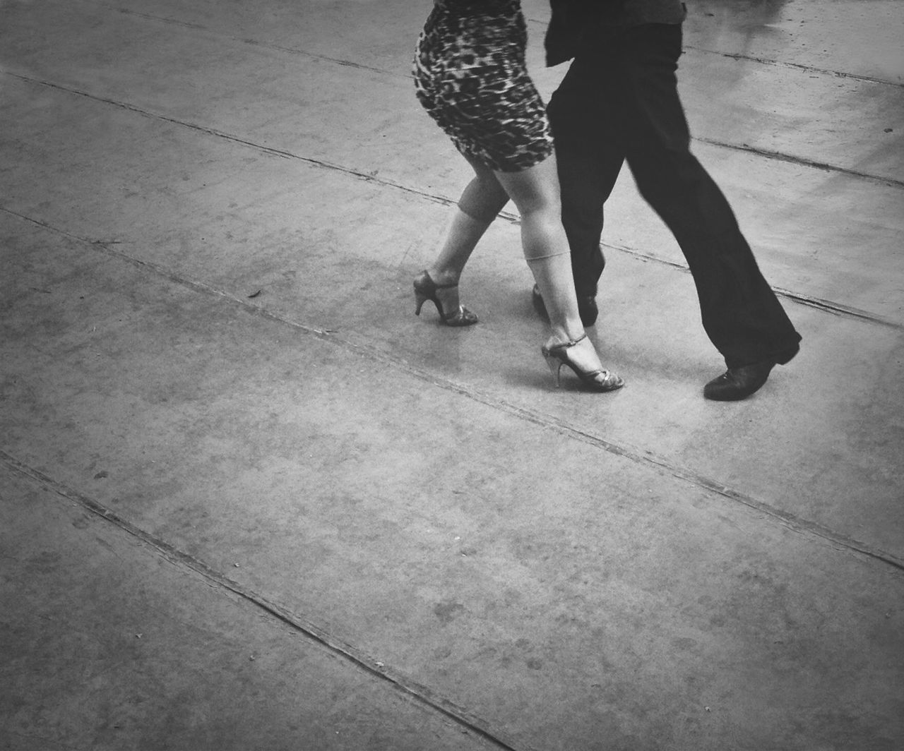 low section, person, lifestyles, walking, men, leisure activity, standing, shoe, human foot, street, high angle view, casual clothing, tiled floor, shadow, on the move