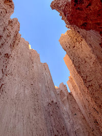 Low angle view of rock formation in desert slot canyon against sky