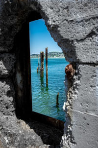 Scenic view of sea seen through hole