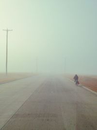 Road passing through foggy weather