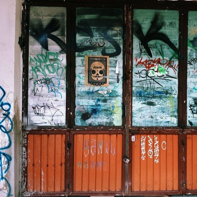 graffiti, art, built structure, architecture, art and craft, creativity, window, wall - building feature, door, building exterior, closed, multi colored, old, indoors, wall, design, street art, day, mural, no people