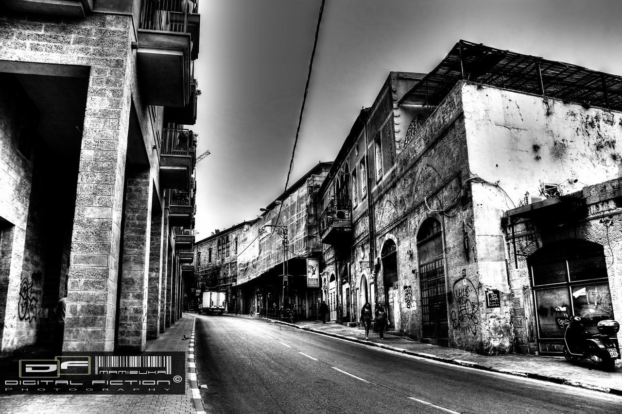 architecture, building exterior, built structure, street, the way forward, sky, road, city, building, diminishing perspective, transportation, residential structure, residential building, outdoors, house, day, no people, street light, vanishing point, low angle view