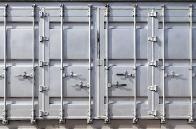 Detailed close up view on metal and steel surfaces on a silver cargo containter