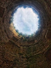 Low angle view of sky seen through hole