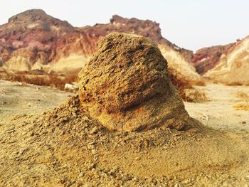 Rock formation on landscape against sky