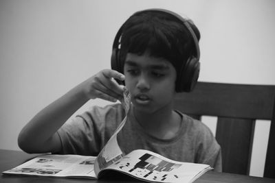 Portrait of boy sitting on table