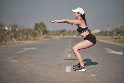 Full length of woman on road