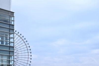 Low angle view of ferris wheel against sky