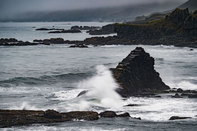 Sea waves splashing on rocks