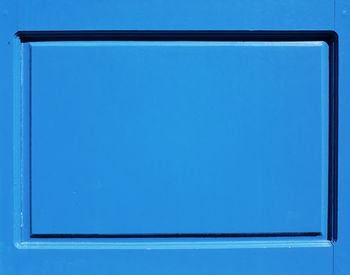 Close-up of metallic structure against blue sky