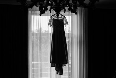 Clothes hanging on window at home