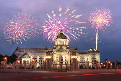 Firework display over city at night