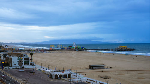 High angle view of city by sea against sky