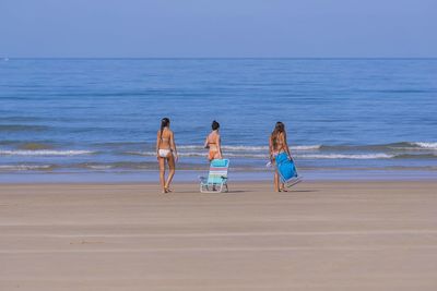 People on beach against sky
