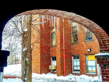 Snow covered building against sky